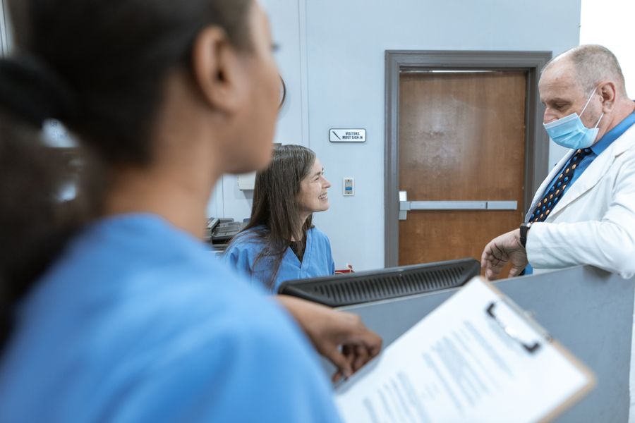 Clinic reception with doctor and patient
